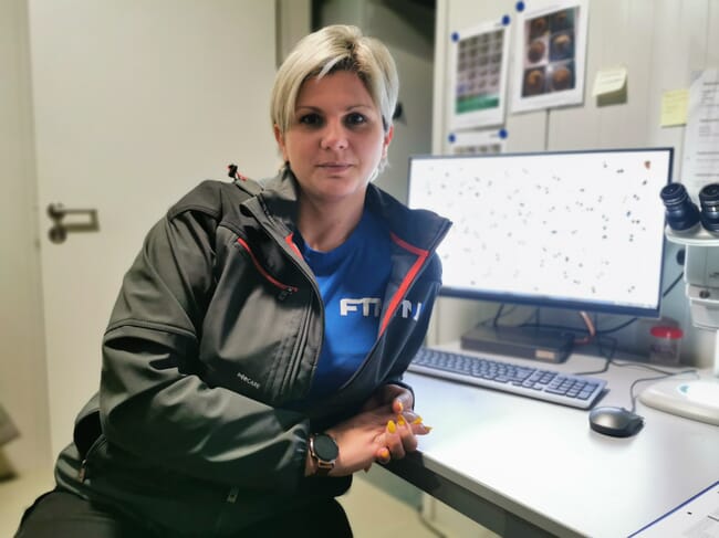 Woman sitting near a computer