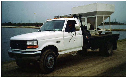 White pick up truck with a feed blower installed on the truck bed